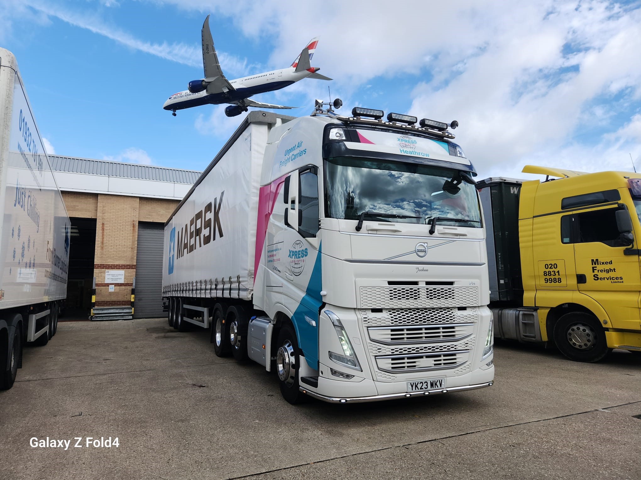 Xpress truck operating beside Heathrow with an aircraft overhead
